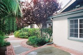 Brick trimmed patio in front of home