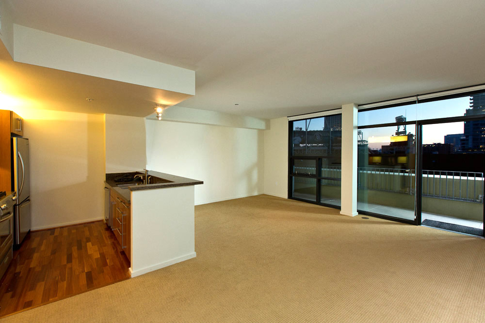 Spacious open living/dining area with floor to ceiling windows