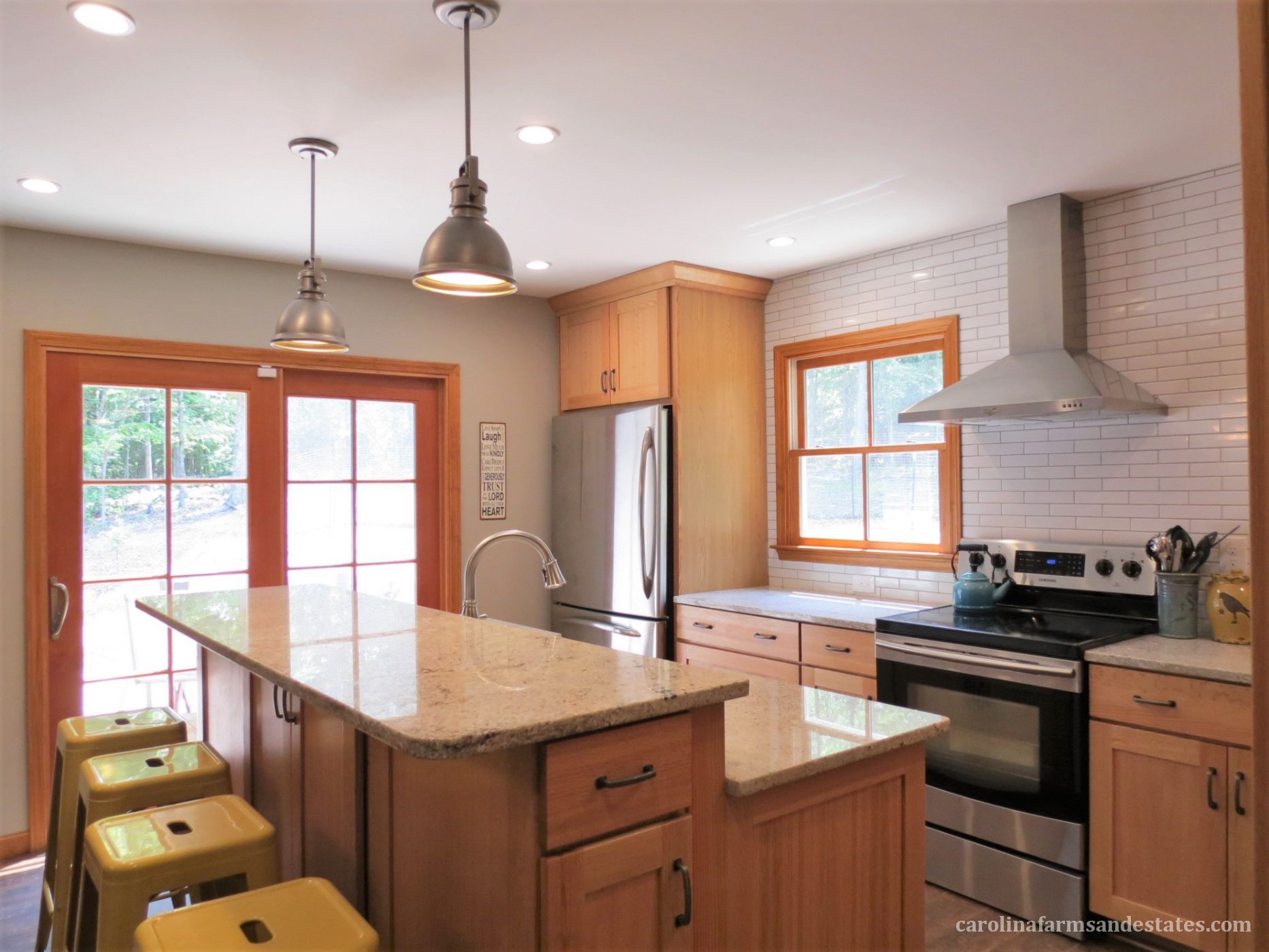 Stainless-steel appliances, industrial style fixtures & classic subway tile wall