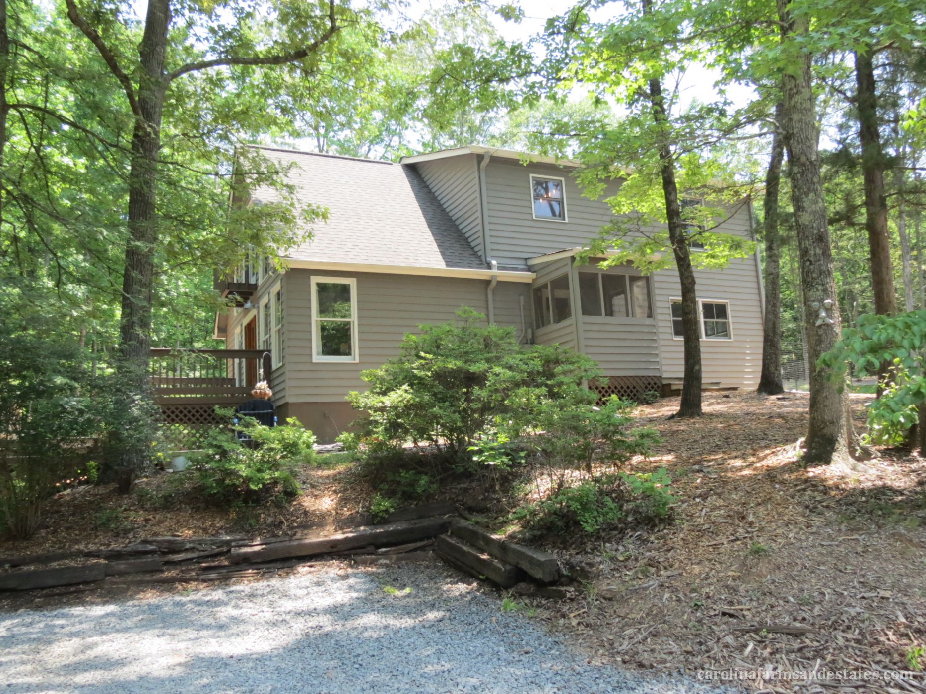 The side view of the home shows how nicely the home sits tucked in among the trees.