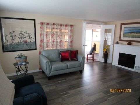 bright living room with new laminate and fireplace