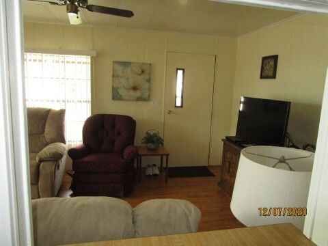 view from kitchen sink into TV area