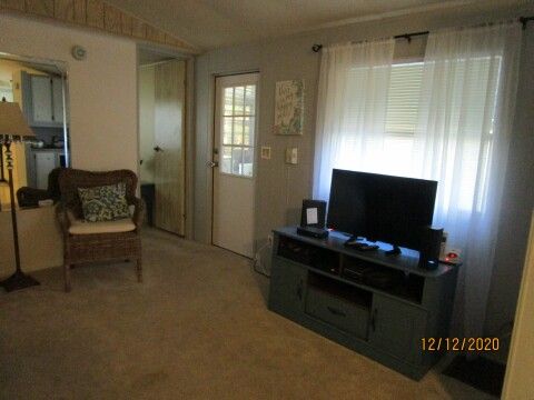 living room TV, stand, entry to raised sc rm