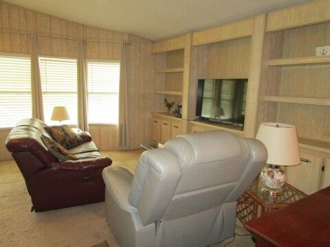 living room, front bay windows, built-in shelving